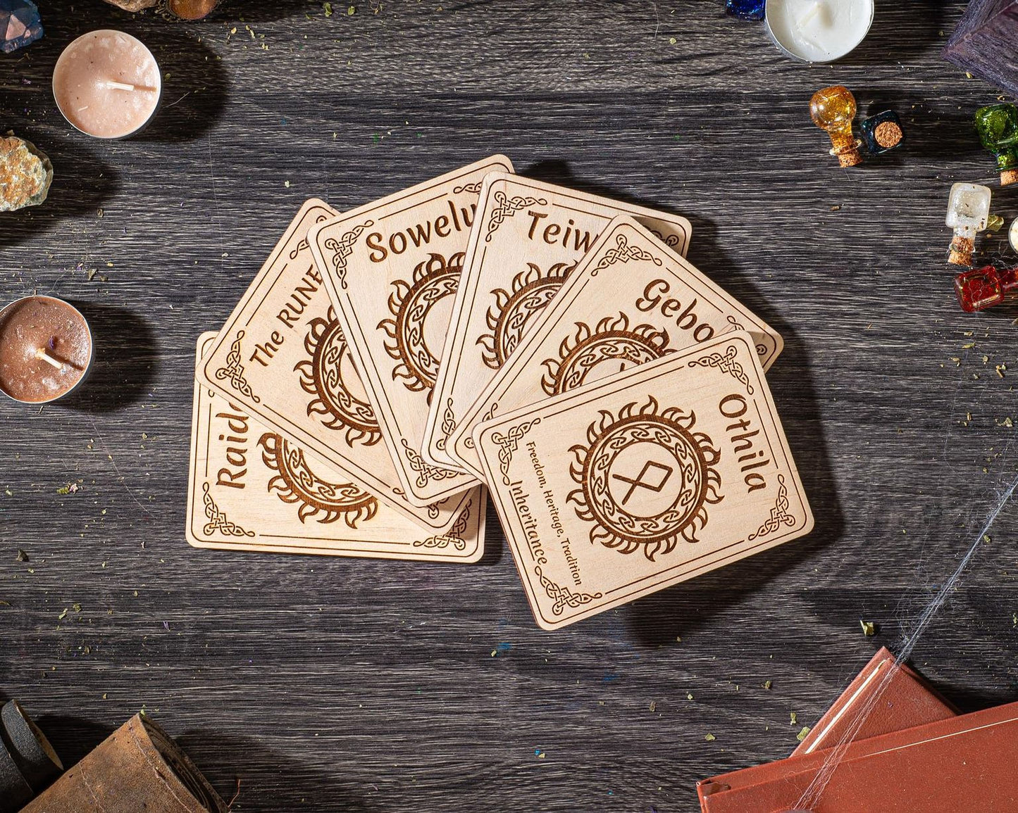 a collection of wooden coasters or cards with various designs and text, placed on a wooden surface.