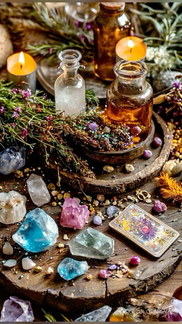 Herbal remedies, bottles, and crystals on a wooden surface with candles and flowers.