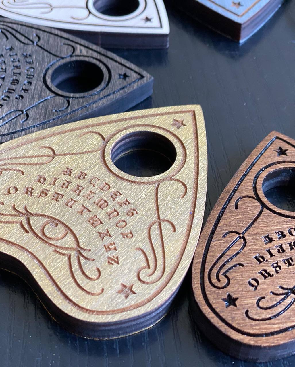 Wooden ouija planchette with natural wood grain and handcrafted finish