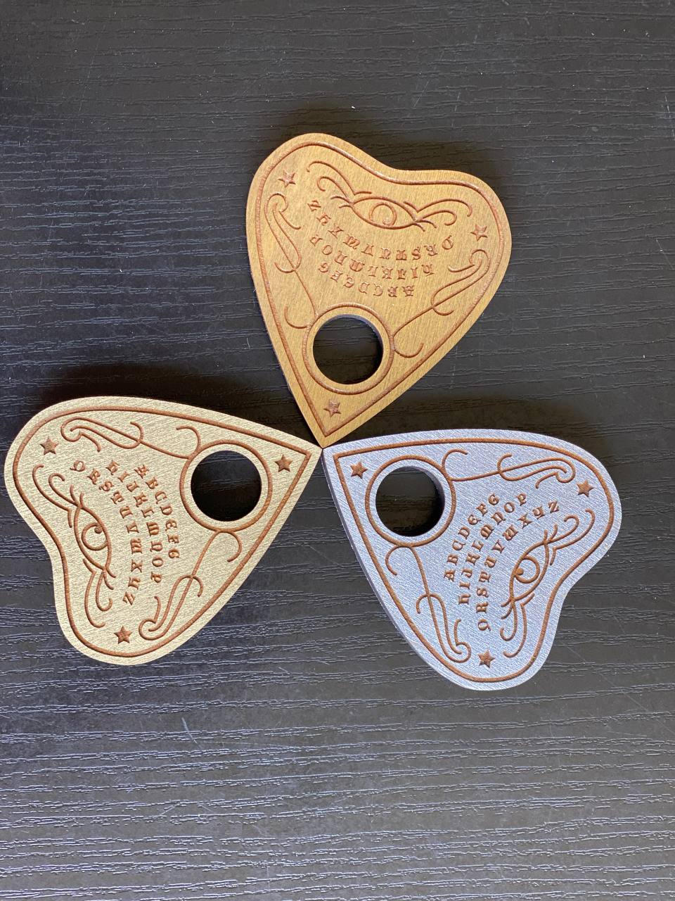 Top view of ouija planchette with classic heart shape and pointer window